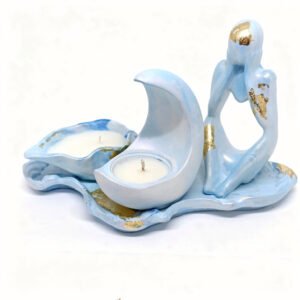 A light blue and gold leaf ceramic candle holder set featuring a figurine in a thoughtful 