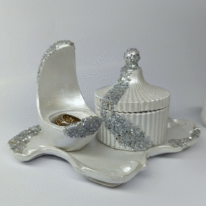 Pearl white concrete vanity set with silver glitter detailing, including a fluted lidded jar, a curved ring holder, and a matching decorative tray.